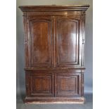 A 19th Century oak library bookcase, the moulded cornice above two arched panel doors, the lower