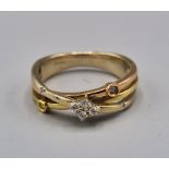 An 18ct gold crossover ring set with four diamonds, 5.1 grams, ring size M