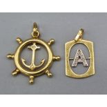 An 18ct gold pendant in the form of a ships wheel together with another 18ct gold pendant in the
