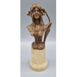 An Art Nouveau patinated bust of a girl with marble socle, 19cms tall