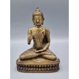 A Chinese patinated model in the form of Buddha, 20cms tall