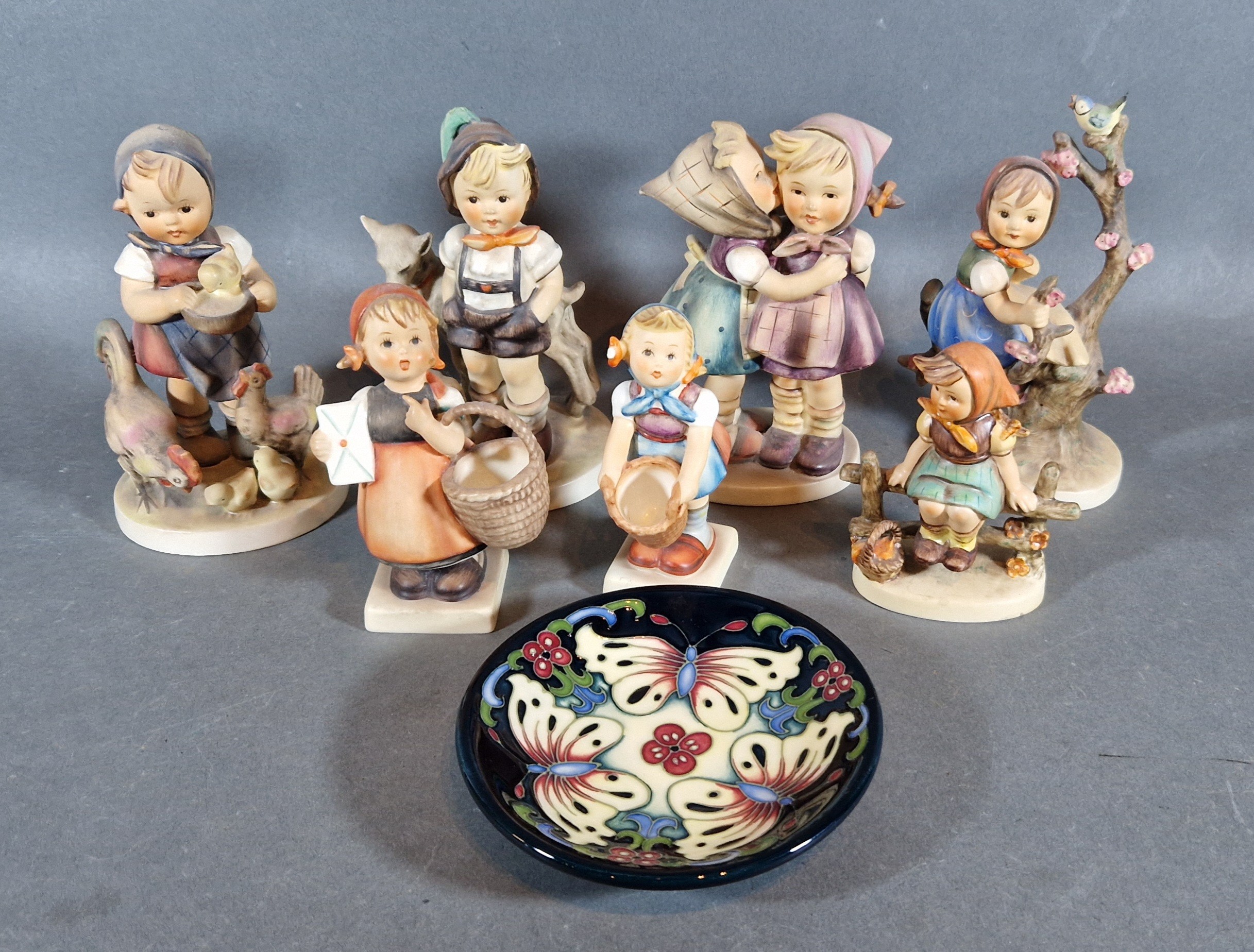 A collection of seven Goebels Hummel figures together with a Moorcroft small bowl