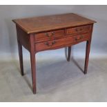 An Edwardian mahogany and inlaid side table with three drawers raised upon square tapering legs,