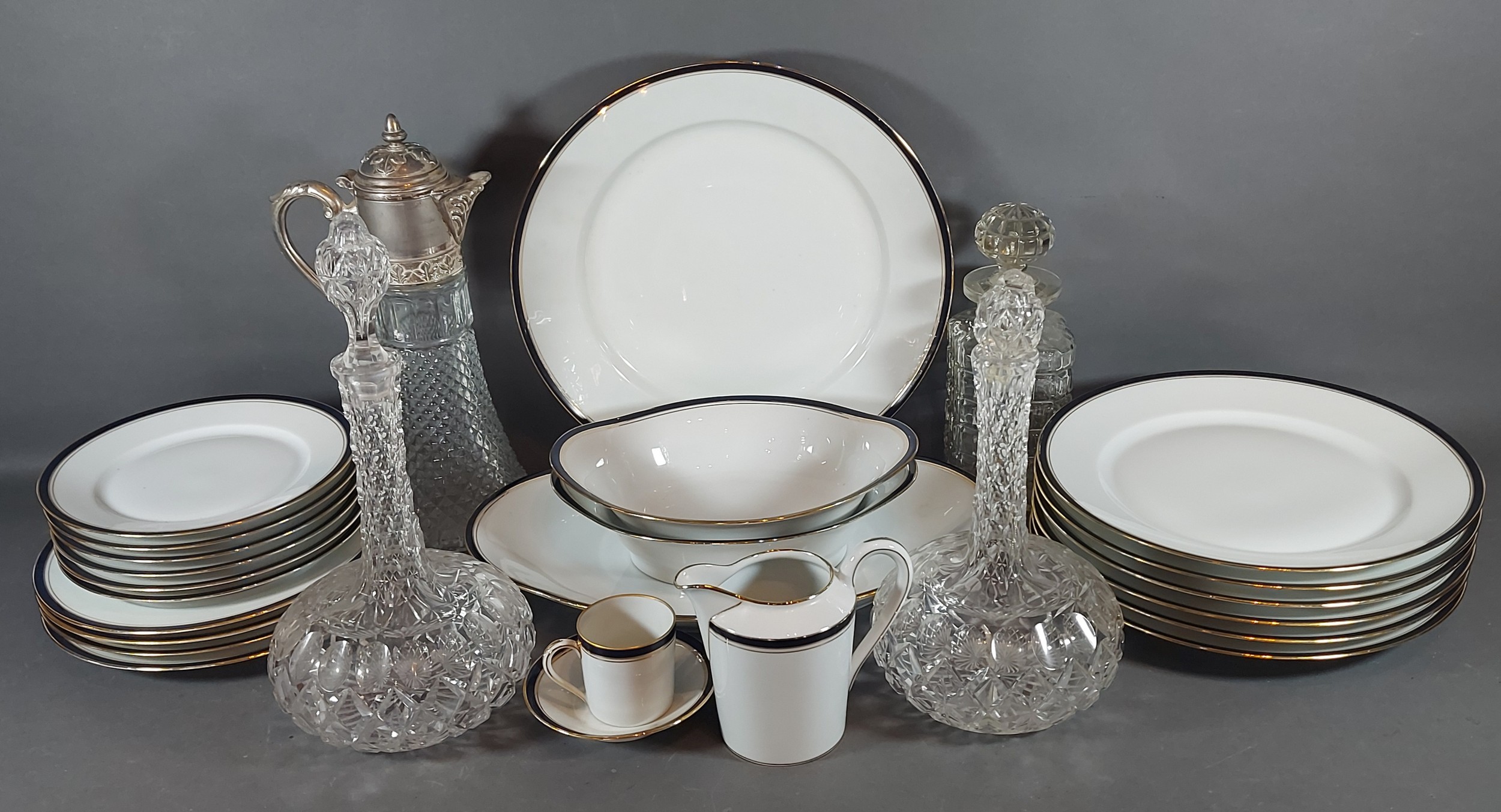 A Limoges porcelain dinner service together with a claret jug and three decanters