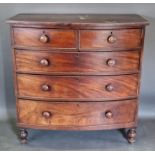 A Victorian mahogany bow fronted chest of two short and three long drawers raised upon turned legs