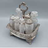 A George III silver cruet set comprising seven cut glass bottles, three with silver mounts, the