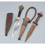An African Tribal Dagger with Leather Scabbard, together with another similar dagger