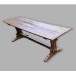 An early oak refectory dining table, the plank top above twin end supports with stretcher, 217cms