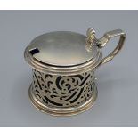 A Victorian large silver mustard of pierced form with blue glass liner, London 1840