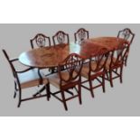 A set of eight Hepplewhite style dining chairs, (two arms and six singles) each with a pierced