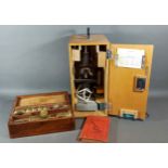 A microscope by Prinz Optics together with another microscope in mahogany box