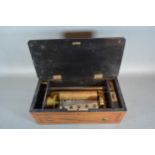 A 19th Century Swiss music box, within an inlaid case, 34cms long
