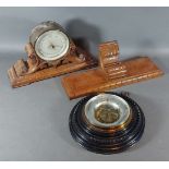 A Negretti and Zambra brass cased barometer thermometer with carved oak stand and wall bracket