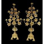 A pair of 19th Century French brass candelabrum, each of flower head form above tri-form