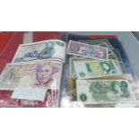 A collection of bank notes both British and foreign to include a twenty pound note, five pound