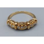 An 18ct gold diamond set band ring set with nine diamonds, 4.3 grams, ring size O
