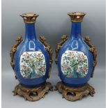 A pair of 19th Century Samson Famille Verte vases with gilt bronze mounts, each decorated with a