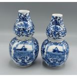 A pair of Chinese porcelain double gourd vases, each decorated in underglaze blue and with four