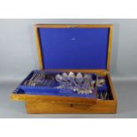 A silver plated canteen of flatware within oak box