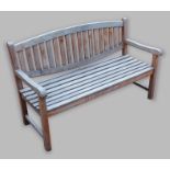 A teak garden bench with slatted back and seat, 150cms long