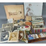 A postcard collection together with early photographs and a collection of cigarette cards