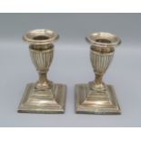 A pair of Birmingham silver dwarf candlesticks with square bases, 12cms tall