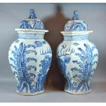 A pair of Chinese underglaze blue decorated covered vases of octagonal form, with serpents amongst