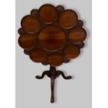 A George III mahogany supper table, the shaped moulded dish top above a bird cage and turned