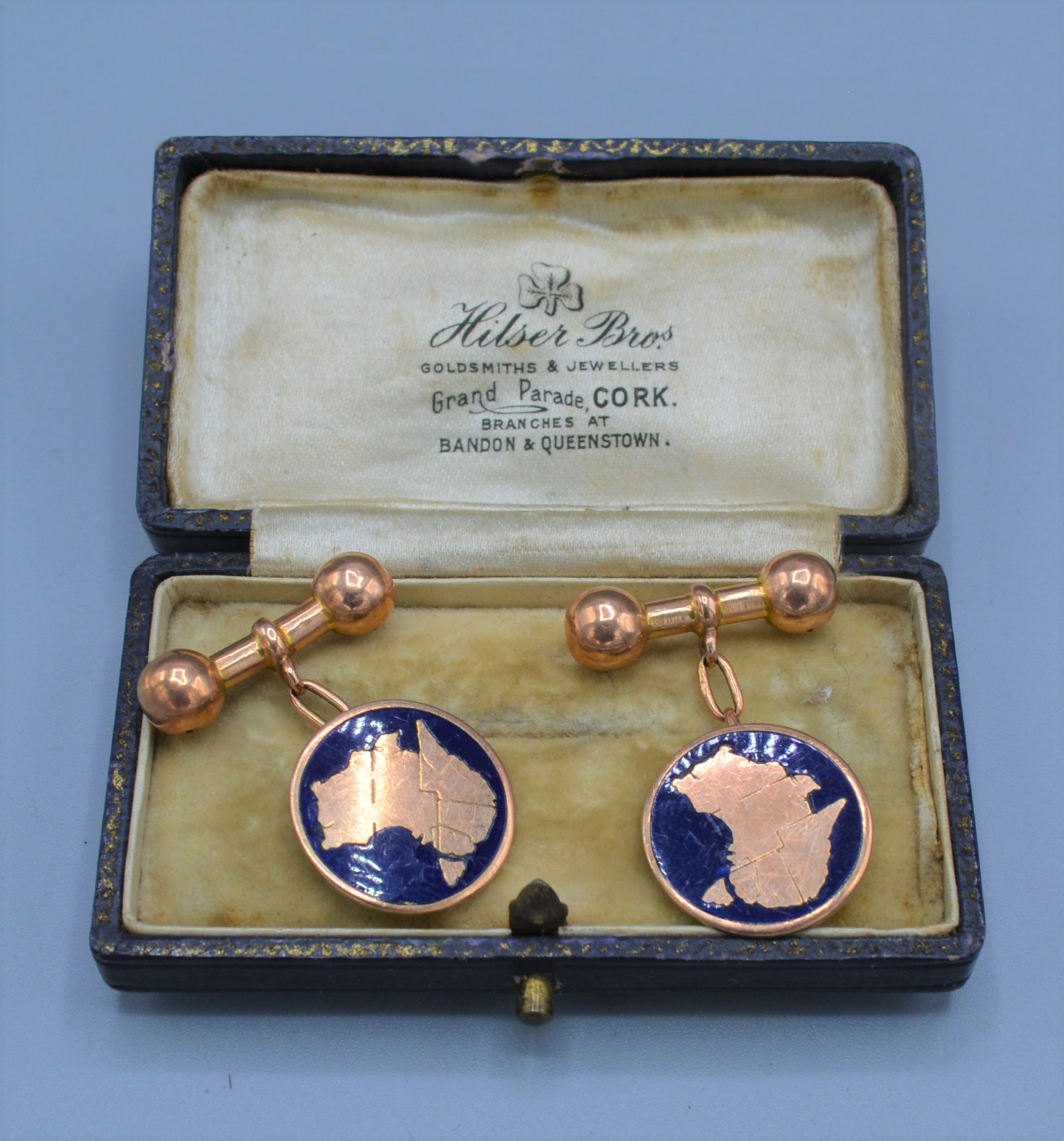 A pair of Australian yellow metal and enamel set cufflinks