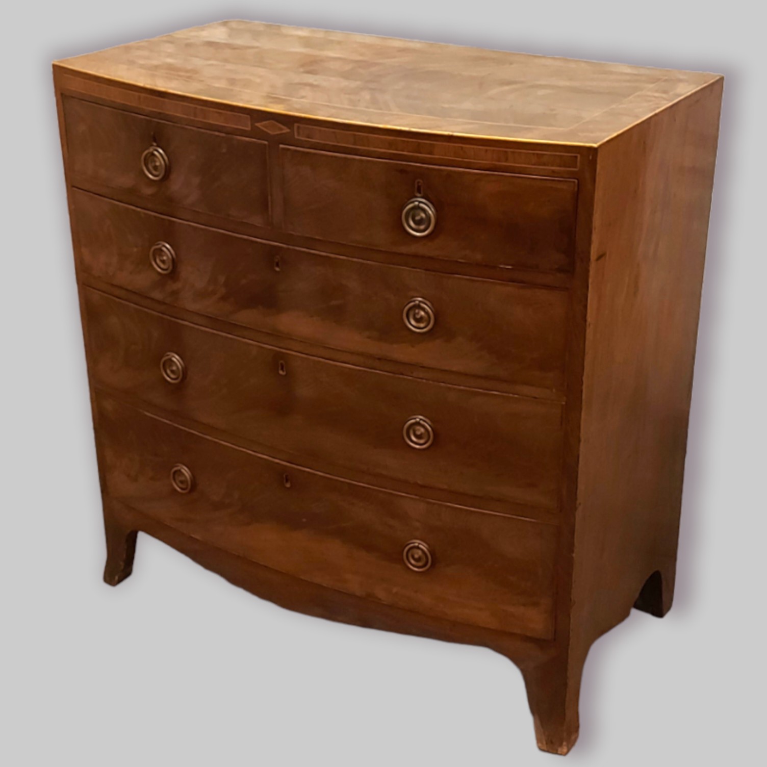 A 19th Century mahogany and inlaid bow fronted chest with two short and three long drawers with