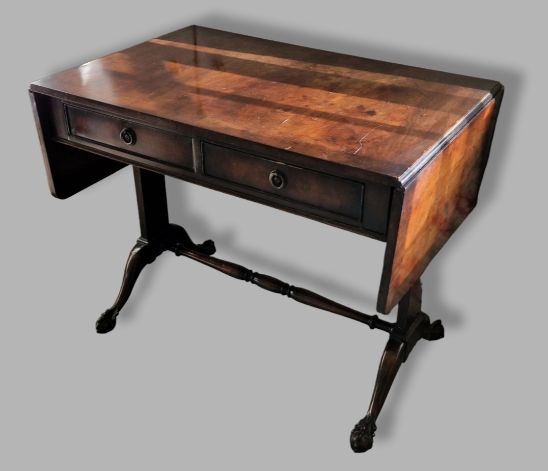 A 20th Century sofa table, the drop flap top above two frieze drawers above twin end supports and