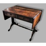 A 20th Century sofa table, the drop flap top above two frieze drawers above twin end supports and