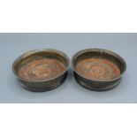 A pair of Georgian silver bottle coasters of lobed form, 14cms diameter