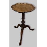 A 19th century mahogany wine table, the shaped moulded top above a tuned wrythen centre column