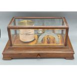 A Barograph by Negretti and Zambra 'Regent' within glazed case above a chart drawer, 42cms long