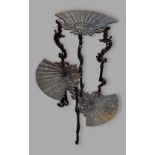 A cast iron jardiniere stand with three platforms in the form of fans and with pierced supports,