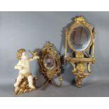 A gilded wall bracket with oval mirrored back together with a brass girandole and a carved gilded