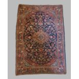 A North West Persian woollen rug with all over design within multiple boarders, 200cm by 135cm