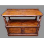 A Victorian mahogany buffet, the moulded top raised on knopped uprights above two doors raised