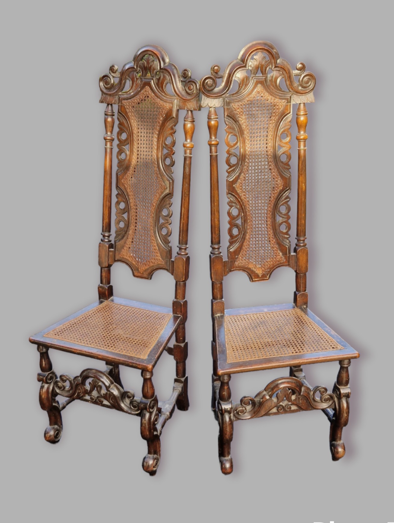 A pair of 19th Century oak Charles II style side chairs, each with a pierced carved and partly caned