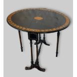 A Victorian ebonised and walnut oval Sutherland table with reeded legs and outswept feet