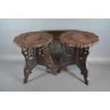 A pair of Eastern carved hardwood and brass inlaid tables, each with a folding base, 30cms tall