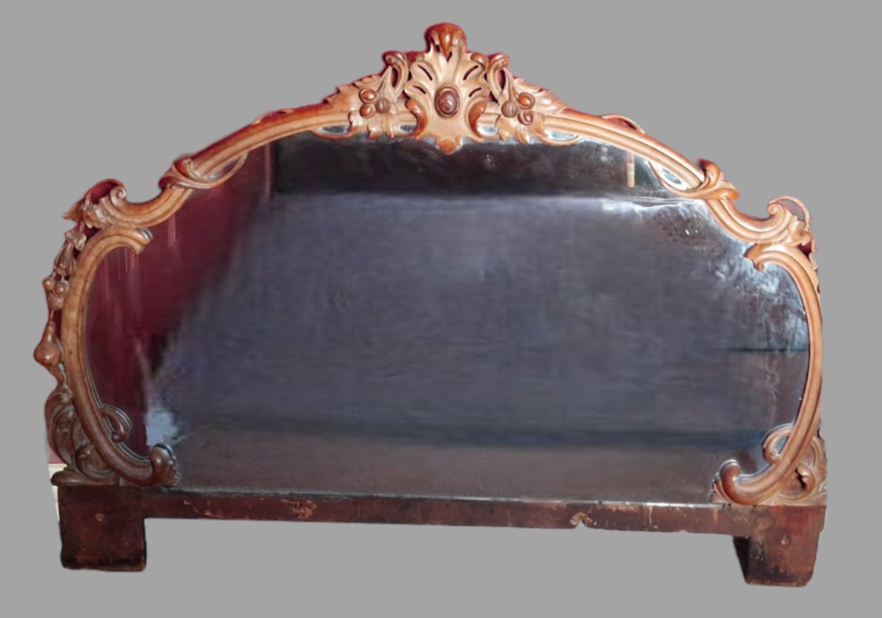 A Victorian large overmantel mirror, the frame carved with fruit amongst scrolls, 105cms tall x