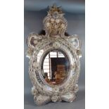 A Venetian glass wall mirror of shaped sectional outline, 77cms x 44cms
