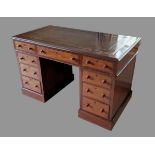 A Victorian mahogany twin pedestal desk, the tooled leather inset top above nine drawers with knob