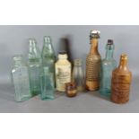 A collection of early glass bottles together with two similar Stoneware bottles