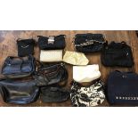 A box of 13 ladies bags black, blue, gold, white, mostly handbags, one make-up bag