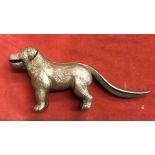 1920s dog shaped nutcracker, cast iron metal with a brass finish, made in England. Lift the tail