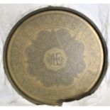 A large Turkish brass table plate which has had a wall hanging mount added, diameter measures 23 1/