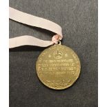 George V 1911 Coronation medallion, which has been struck by 'The Makers of Elect Cocoa' to